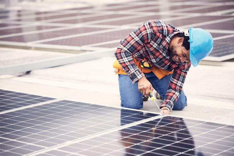 Technician Installing Solar Panels